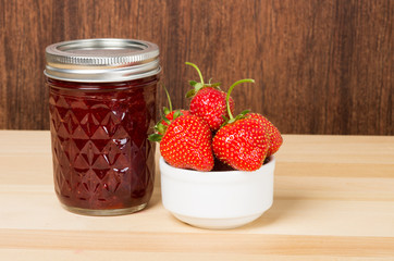 Strawberry jam or jelly with bowl of strawberries