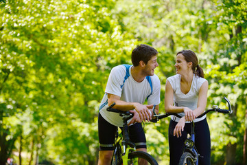 Fototapeta premium Happy couple riding bicycle outdoors