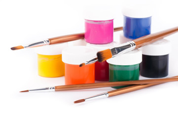 Pencils, paints and brushes on a white background