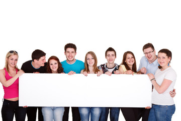 group of friends standing together with white billboard