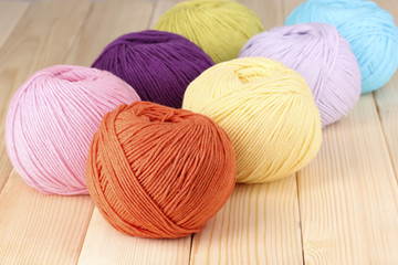 Knitting yarn on wooden background