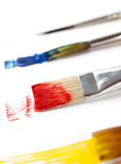 Paintbrushes with ink are lying on white background, isolated