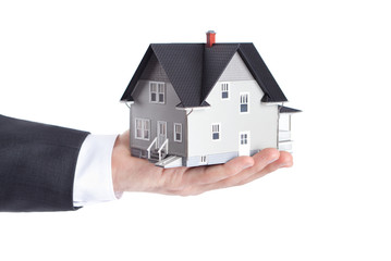 Realty concept - hand holding house model