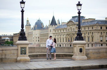 Dating couple in Paris on a bridge