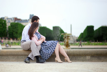 Romantic couple sitting by the water in Luxembourg garden of Par