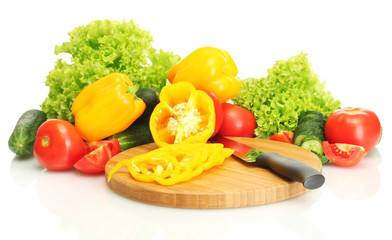 fresh vegetables and knife on cutting board isolated on white