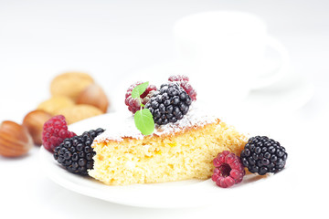 cup, cake, raspberry, blackberry,nuts and mint on a plate on a w