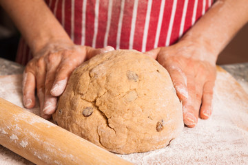 Hands kneeding a dough