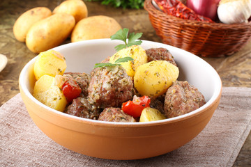 Meatballs with tomato sauce with potatoes in broth