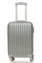 Front view of silver travel suitcase standing over white