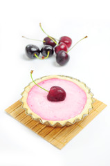 Cherry tart and cherries in the background
