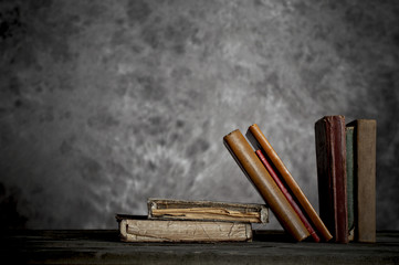 Tattered antique books in a grunge library