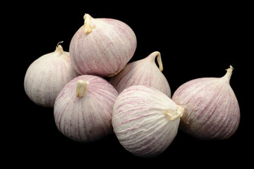 Heap of garlics isolated over black background