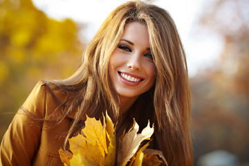 young brunette woman portrait in autumn color