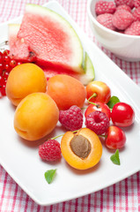 Summer fruits, watermelon, raspberries, cherries and apricots
