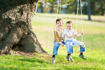 Children on a swing on a nature