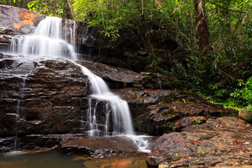 Naklejka na ściany i meble Waterfall in tropical forest, east of Thailand