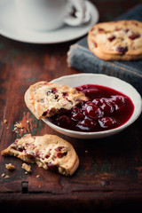 Cranberry cookie and sour cherry jam on a rustic table