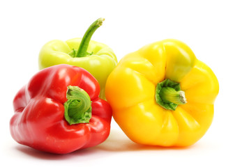 fresh yellow, red and green bell peppers isolated on white