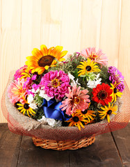 Fototapeta na wymiar Beautiful bouquet of bright flowers in sacking