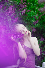 Fototapeta premium Woman with a lilac flowers.