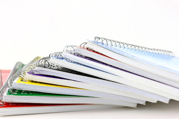 Pile Of Spiral Notebooks End View On White
