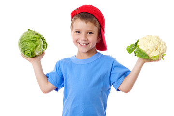 Smiling kid with cabbage and cauliflower