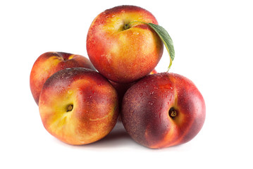 ripe nectarines fruit with green leafs