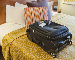 Roll Aboard Bag on a Hotel Bed