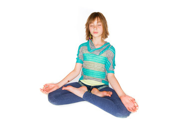 Young girl meditating in a yoga class