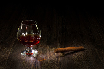Cognac, cigar and an old book nearby