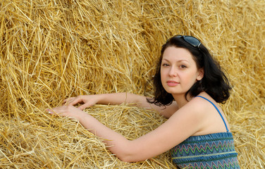 Young attractive woman on the background of the large stack of h