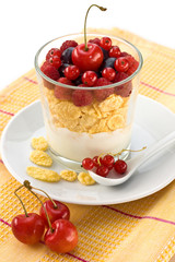 corn flakes, yogurt, berries in a clear glass