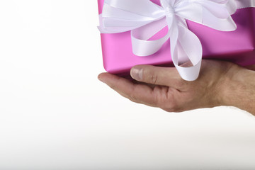 gift in purple paper holding in hand