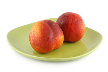 Two fresh nectarine isolated on white