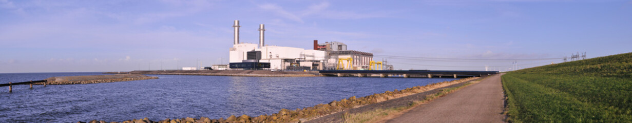 Panorama with an electrical power station at the shore