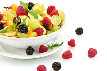 fresh fruits salad in bowl  and berries, isolated on white