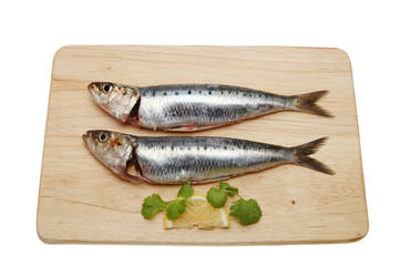 Two sardines on a board