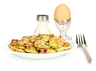 Fried zucchini with eggs for breakfast isolated on white
