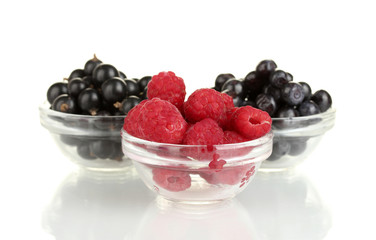 Fresh berries in transparent bowls isolated on white