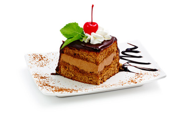 Chocolate cake with cherry and fresh mint isolated