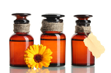 medicine bottles and beautiful calendula flower, isolated
