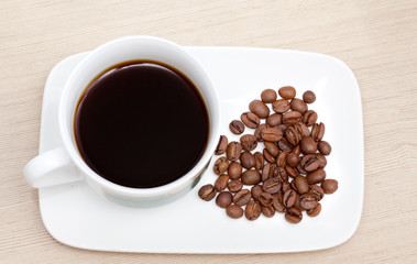 Cup of black coffee and beans