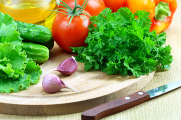 Fresh vegetables for the salad on a cutting board