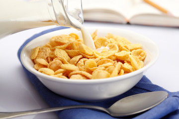 Pouring milk over cornflakes