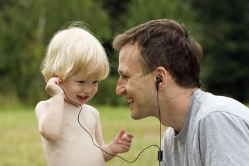 The child listens to music in earphones