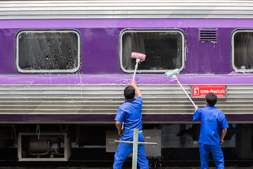 Worker washing the train
