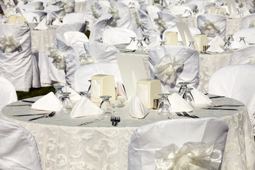 Empty served restaurant table with white tablecloth