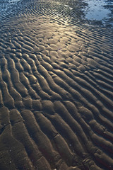 textured sand on a beach in the sunset time