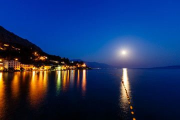 Small Dalmatian Village and Adriatic Sea Bay Illuminated by Moon